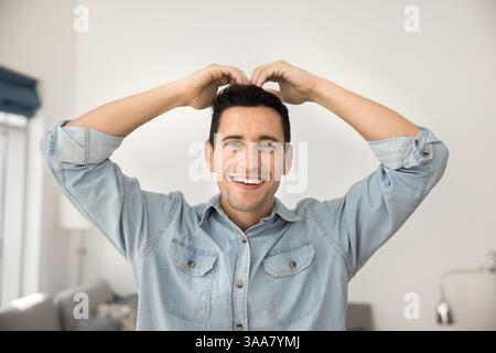 Man making heart gesture above his head using his hands Stock Photo