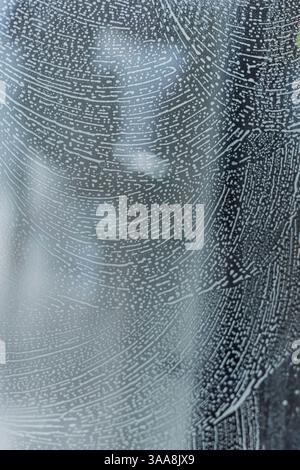 soap foam pattern wipe marks on window glass, window cleaning , blue background. High quality photo Stock Photo
