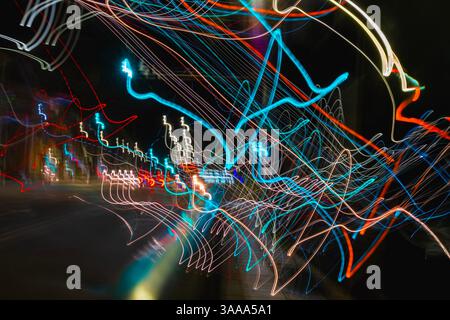 Colorful long exposure light trails in abstract chaotic composition on black night background. Light neon painting expresses motion, Dynamic light tra Stock Photo