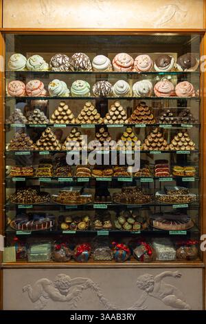 A display of many different types of pastries, including cupcakes and donuts. There are at least 15 different types of pastries on display Stock Photo