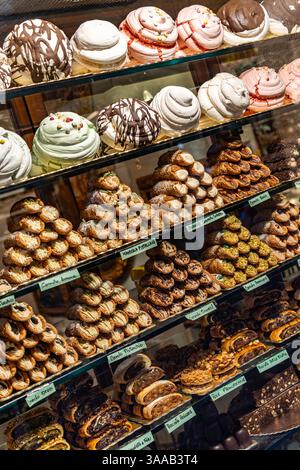 A display of many different types of pastries, including cupcakes and donuts. There are at least 15 different types of pastries on display Stock Photo