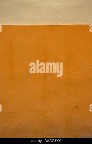 Vibrant orange wall texture with a subtle beige stripe, perfect for background, design inspiration or artistic project. Image of imperfections and uni Stock Photo