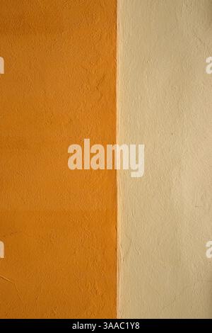 Vibrant orange wall texture with a subtle beige stripe, perfect for background, design inspiration or artistic project. Image of imperfections and uni Stock Photo