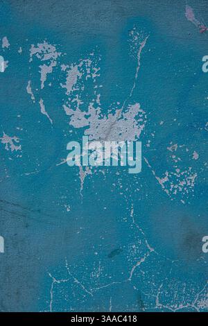 Peeling paint and cracked blue wall texture background. Weathered decayed urban surface with chipped paint and cracks. Distressed, rustic aesthetic fo Stock Photo