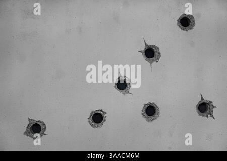 Close-up of movie set featuring replicas of fake bullet holes on a gray concrete wall, carefully crafted by set designers, captured with a high-resolu Stock Photo