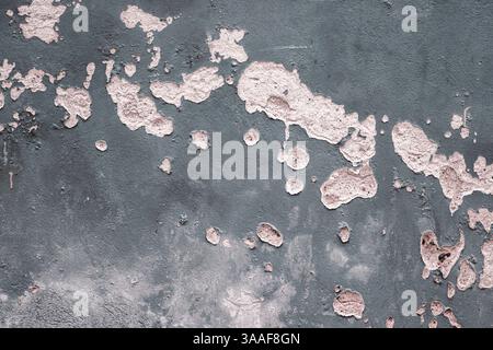 Weathered, peeling blue gray paint on an old concrete wall, revealing underlying bricks. Rough textures, cracks, and faded colors. Copy space Stock Photo