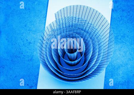 Abstract artistic geometric spiral wire mesh with detailed curves and shadows, suitable for abstract backgrounds, geometric design, and creative photo Stock Photo