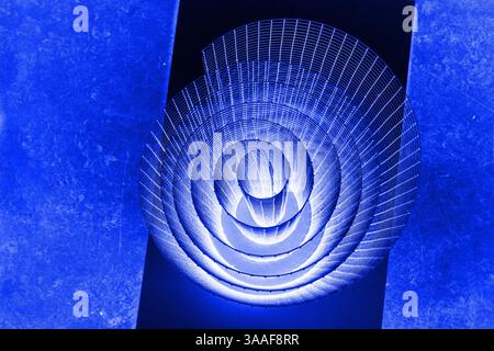 Abstract spiral with glowing blue, lilac, violet, purple tones and wire texture against a black background, symbolizing energy, motion, industrial and Stock Photo