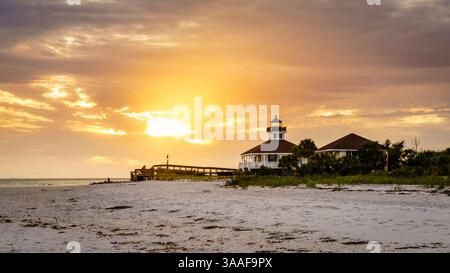 Scenic sunset over lighthouse and the beach in Воса Grande, Florida Stock Photo