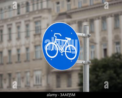 Bicycle path traffic sign in Austria. Close up of the cycle icon on a blue background. The symbol indicates a dedicated way or lane for cyclists. Stock Photo