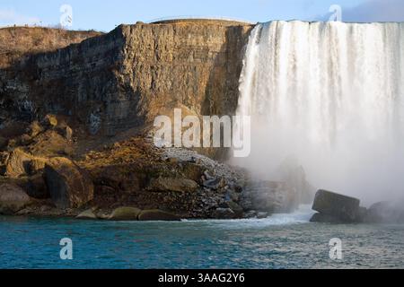 Looking out from the Niagara Parks Power Station tunnel towards Horseshoe Falls, Niagara Falls, Canada as the sunlight illuminates the cascading water Stock Photo