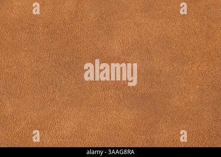 Natural light brown suede texture. Genuine shammy-leather with slight shabby texture, pattern or background, close-up, high resolution. Stock Photo