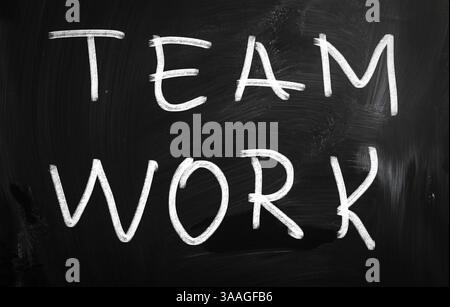 Teamwork handwritten with white chalk on a blackboard Stock Photo
