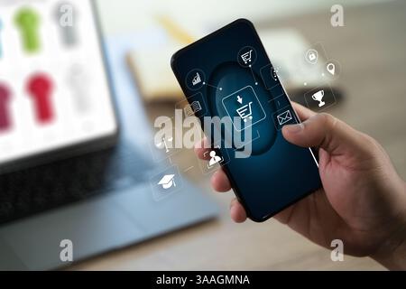 man is using a smartphone to browse a shopping app, clicking to purchase fashion items online, embracing modern e-business trends. Stock Photo