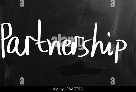 The word 'Partnership' handwritten with white chalk on a blackboard Stock Photo