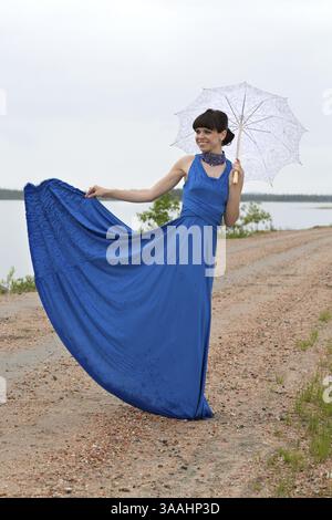 Beautiful dark haired model strolling through the woods Stock Photo