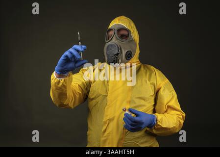 Man in protective suit with gas mask during a disaster drill Stock Photo