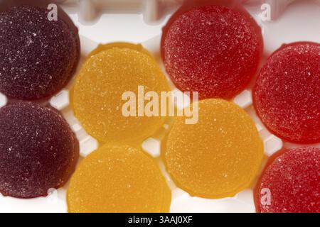 Round jelly sprinkled with sugar in a plastic box Stock Photo