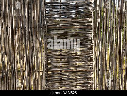 Woven wooden fence of twigs of hardwood Stock Photo