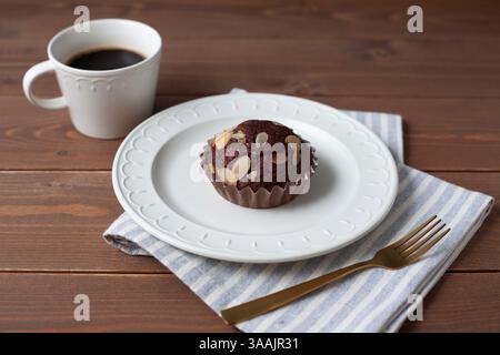 chocolate cupcake muffin with coffee isolated on wodden table Stock Photo