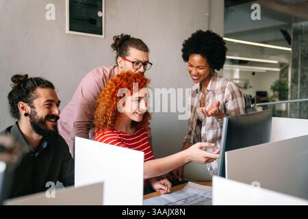 Mixed team of software engineers brainstorming ideas. Diverse app developers collaborating as group Stock Photo