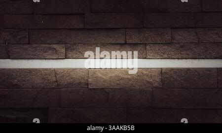 Interesting facade decorative bricks under dramatic lighting. Stock Photo