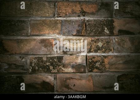 Interesting facade decorative bricks under dramatic lighting. Stock Photo
