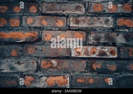 Interesting facade decorative bricks under dramatic lighting. Stock Photo