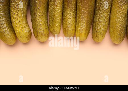 Pickled cucumbers on orange background Stock Photo