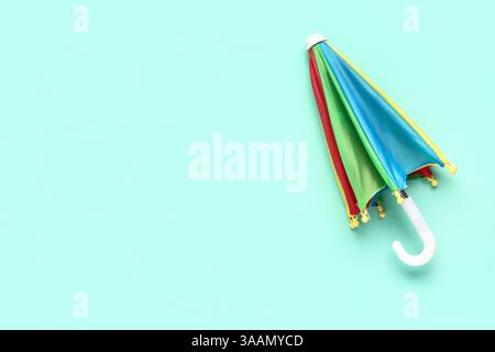 Mini colorful umbrella on green background Stock Photo