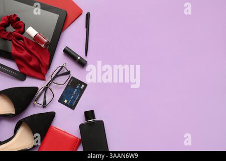 Composition with stylish female accessories, shoes and modern gadgets on lilac background Stock Photo