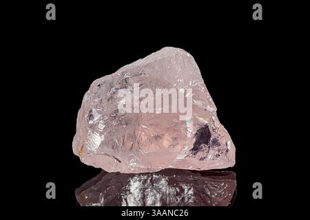 Natural rough rose quartz gemstone on dark background Stock Photo