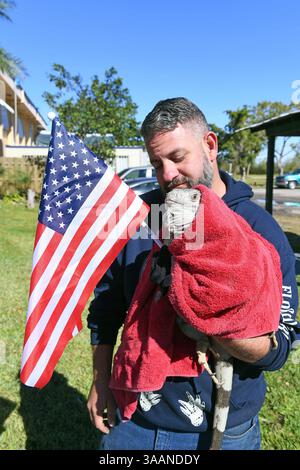 January 5, 2018 - Weston, Florida, United States Of America - WESTON, FL - JANUARY 05: (EXCLUSIVE COVERAGE) Brutal cold sends shivers through Northeast after 'bomb cyclone. Florida Fish and Wildlife Conservation Commission officials said iguanas can become immobilized or sluggish when temperatures hit between 40 and 50 degrees. Iguanas all over the state are falling out of trees after becoming to cold. Seen here tourist and guides dress warm for the airboat ride as  employee Tim is talking care of ''IGGY'' the baby Iguana by wrapping him in a blanket and even putting gloves on him to keep him Stock Photo
