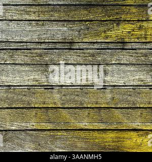 Old yellow painted wooden boards forming a rustic background Stock Photo