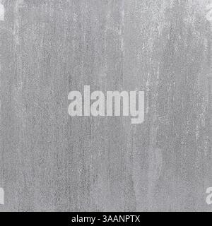 Gray concrete wall showing signs of age and wear creates textured background Stock Photo