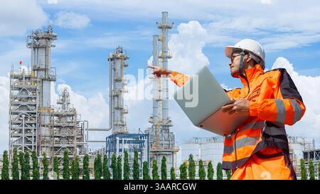 Asian Japan Petroleum industry engineer worker working at Refinery plant oil and gas maintenance service team with laptop computer. Stock Photo