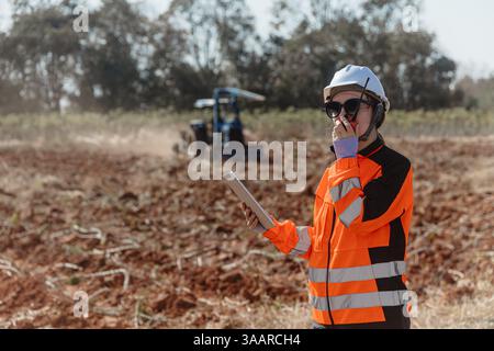 Builder engineer worker outdoor working in construction site wearing safety suit control operate land leveling process for land development Stock Photo