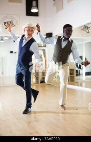 Two professional dancers practicing lindy hop in dance class Stock Photo