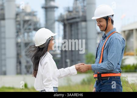 Professional Petroleum Refinery engineer team hand shaking together dealing oil gas building project Stock Photo
