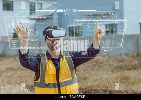 Engineer male worker using Visual reality VR or Augmented reality AR technology in construction industry. Modern digital innovation in engineering con Stock Photo