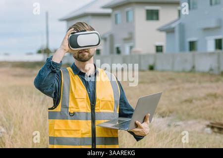 Engineer male worker using Visual reality VR or Augmented reality AR technology in construction industry. Modern digital innovation in engineering con Stock Photo