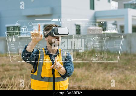 Engineer male worker using Visual reality VR or Augmented reality AR technology in construction industry. Modern digital innovation in engineering con Stock Photo
