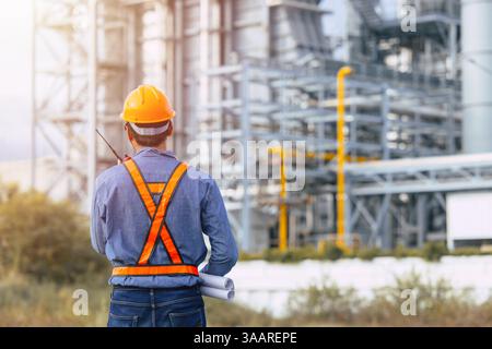 Professional Petroleum Refinery engineer man working building oil and gas power industrial plant. Petrochemical power plant industry professional work Stock Photo