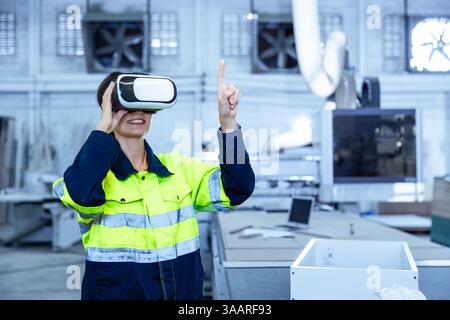 Modern Factory Innovation Technology in Industry, Technician female using VR Virtual Reality Headset in Wood furniture design workshop. Stock Photo