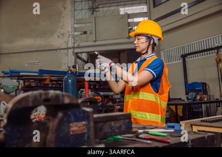 Engineer women working in Lathe shop with metal machinery lathe milling machine, expert skillful industry worker female. Stock Photo