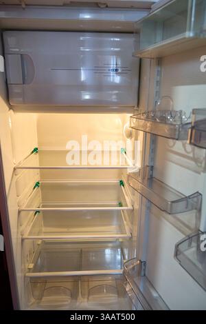 Empty refrigerator interior, a pristine and sterile scene evokes feelings of fresh starts, minimalist living, or the anticipation of a grocery shoppin Stock Photo