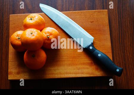 Orange Halves on Wooden Board with Knife. High-Resolution Stock Image Stock Photo
