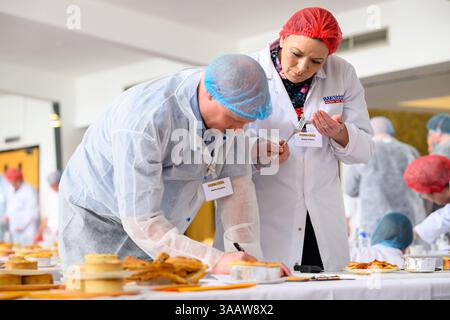 PIEONEERS BATTLE IT OUT FOR RECORD-BREAKING PIE-OFF AT 25TH ANNUAL WORLD CHAMPIONSHIP SCOTCH PIE AWARDS  Over 530 pies compete for crowning glory – bi Stock Photo