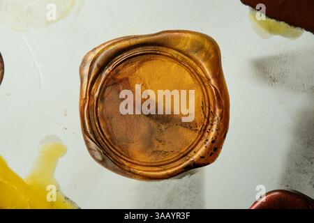 Golden vintage wax seal stamp on old paper Stock Photo
