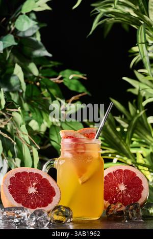Refreshing drink with grapefruit and rosemary in a glass on a wooden ...